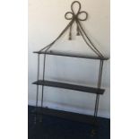 An attractive brass mounted wall shelf with bow to