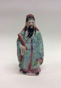 A Chinese figure of a man with blue ground shawl.