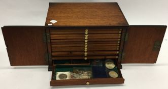 A mahogany coin case with fitted interior complete