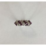 An 18 carat ruby and diamond twist ring. Approx. 6