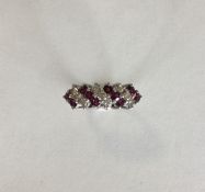 An 18 carat ruby and diamond twist ring. Approx. 6