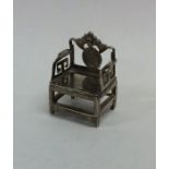 A small novelty silver model fo a chair on stretch