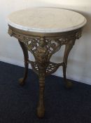 A marble top cast iron pub table of typical design