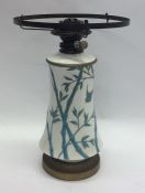 A Mintons pottery oil lamp on tapering supports. E