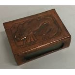 A small copper match case decorated with a fish. E