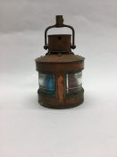 A small copper mounted Marine lamp with hinged top