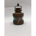 A small copper mounted Marine lamp with hinged top