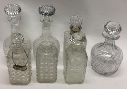 A silver mounted glass decanter together with six