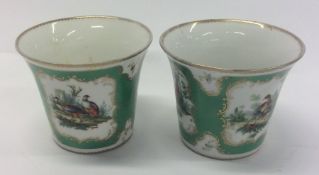A pair of attractive candle holders with gilt rims