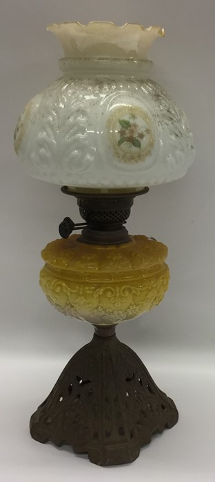 An Edwardian lustre oil lamp decorated with flower