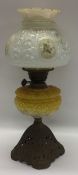 An Edwardian lustre oil lamp decorated with flower