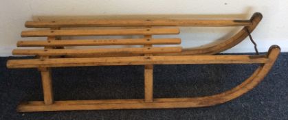An old wooden sledge. Est. £25 - £35.
