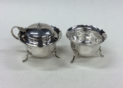 An Edwardian two piece silver cruet on spreading s