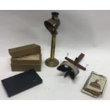 An old slide viewer together with slides and an old lacemaker's lamp.