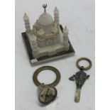 A carved model of the Taj Mahal together with a si