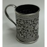 A small Indian tapering silver cup decorated with