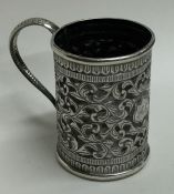 A small Indian tapering silver cup decorated with