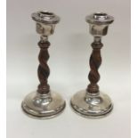 A pair of stylish silver and oak barley twist cand