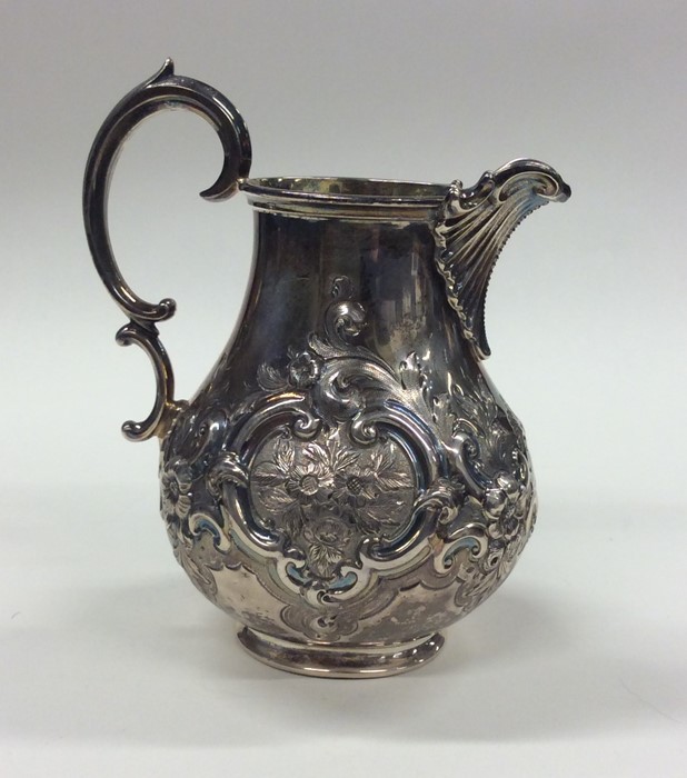 A good Victorian embossed silver cream jug decorat - Image 3 of 3