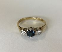 An 18 carat sapphire and diamond three stone ring.