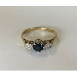 An 18 carat sapphire and diamond three stone ring.