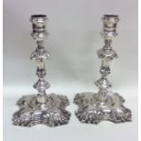 A good pair of cast Georgian silver candlesticks w