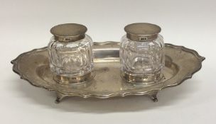An Edwardian silver two bottle inkstand with shape