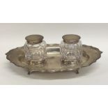 An Edwardian silver two bottle inkstand with shape