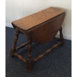 An oak two lap drop leaf table on spreading turned