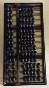 An old wooden abacus. Est. £20 - £30.