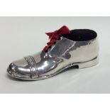 A novelty silver pin cushion in the form of a shoe