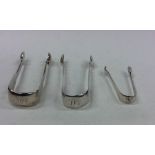 Two pairs of fiddle pattern silver sugar tongs tog
