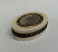 An attractive oval Antique ivory silver and gold m