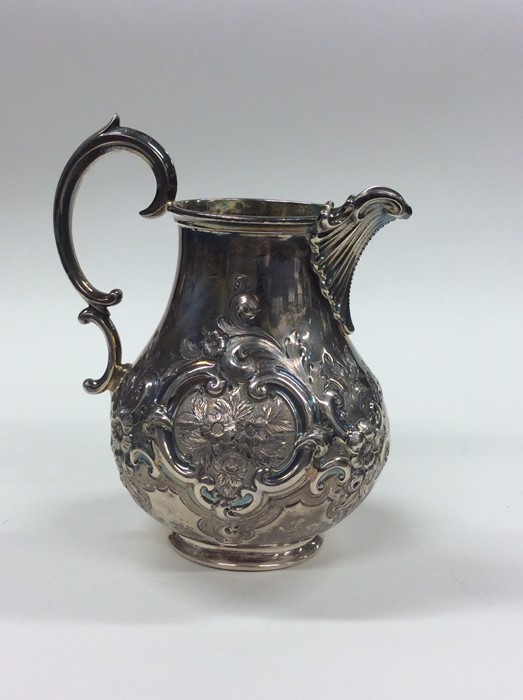 A good Victorian embossed silver cream jug decorat - Image 2 of 3