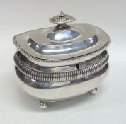 A Georgian silver boat shaped tea caddy with flute