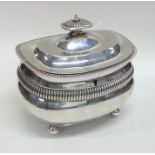 A Georgian silver boat shaped tea caddy with flute