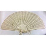 An attractive carved ivory fan with lacework decor