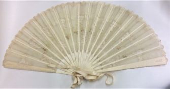 An attractive carved ivory fan with lacework decor