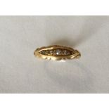 An 18 carat diamond boat shaped five stone ring. A