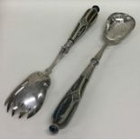 A pair of Doulton Lambeth salad servers with plate