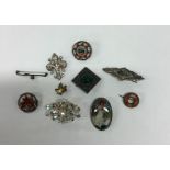 A bag containing silver and other brooches. Est. £