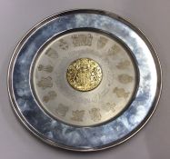 A large silver commemorative charger with gilt cen