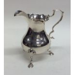 A Georgian silver helmet shaped cream jug with wav