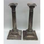 A matched pair of tall silver Corinthian column ca