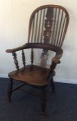 An Antique oak stick back kitchen chair on taperin