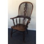 An Antique oak stick back kitchen chair on taperin