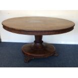 A large mahogany circular tilt-top Loo table on ta