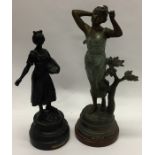 Two spelter figures on circular pedestal bases. Es