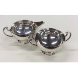 An Edwardian silver cream jug together with matchi