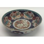 A decorative Chinese bowl inset with dragons and g